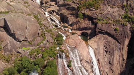 scenic aerial view of the majestic ezaro waterfall (fervenza do ezaro) in dumbria, la coruña, galicia, spain- drone shot
