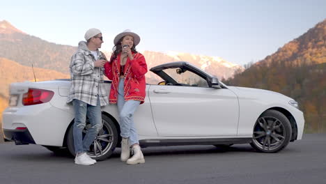 couple enjoying a scenic road trip in a convertible