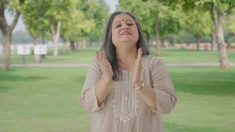 Happy-Indian-old-woman-clapping-and-appreciating-in-park