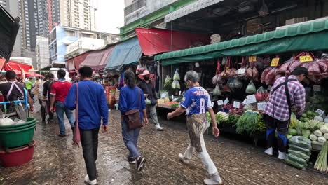 people shopping and walking in a busy market.