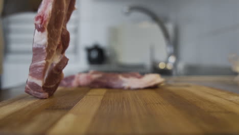 Nice-piece-of-raw-meat-lying-down-to-a-wooden-desk-in-the-kitchen,-animal-protein