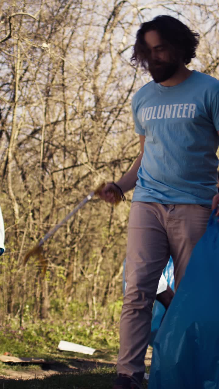 Volunteers Cleaning Up Litter in a Forest with Trash Grabbers