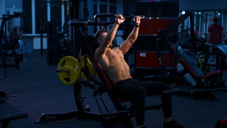 fit young man lifting barbells doing workout at a gym. sport, fitness, weightlifting, bodybuilding, training, athlete, workout exercises concept. view from the side.