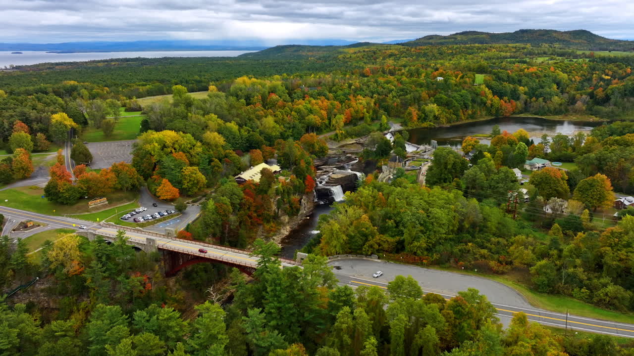 Scenery of Lake Champlain surrounded by colorful woodlands. Aerial perspective on the picturesque nature of North New York State in autumn. Aerial view.