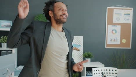 happy man dancing in office