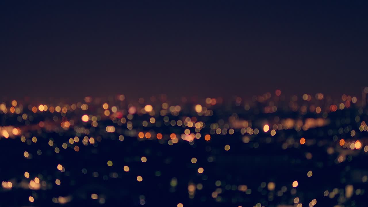 A stunning aerial view of a city illuminated by twinkling lights at night