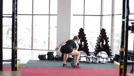 back view woman lifting weight squatting with barbell in gym sporty woman exercising back view woman lifting weight squatting with barbell in gym sporty woman exercising high quality photo