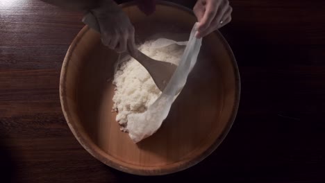 chef steams rice in traditional way