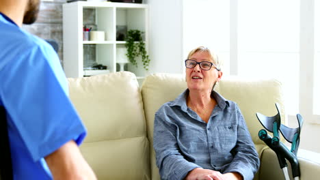 male nurse and senior woman having a conversation
