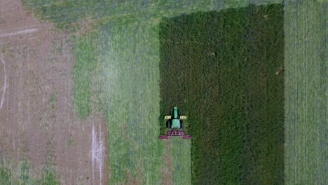 Pull-out-shot-of-Farmer-plowing-the-land-aerial