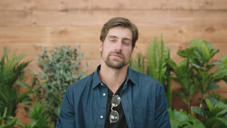 attractive-young-man-portrait-of-handsome-caucasian-guy-arms-crossed-looking-pensive-serious-at-camera