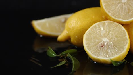 juicy lemons with leaves lying on the water.