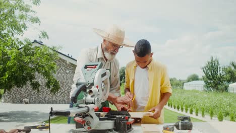 grandfather teaching grandson woodworking