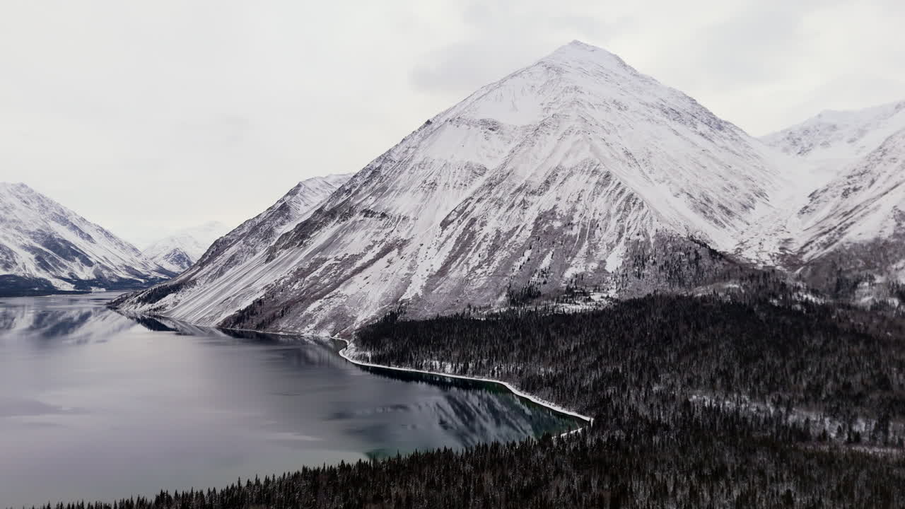 Snow Mountain Ridge Over Kathleen Lake During Winter In Kluane National Park And Reserve, Yukon Canada. Aerial Shot