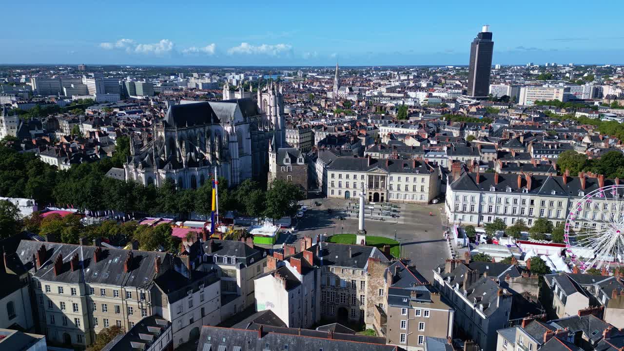 Marechal-Foch square with Louis-XVI column and Tour de Bretagne tower in background, Nantes in France. Aerial drone backward and cityscape