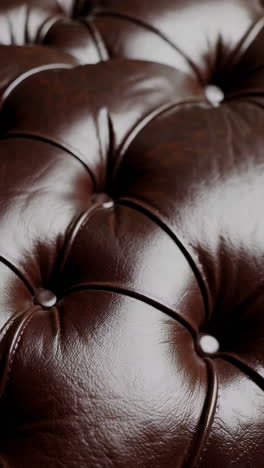 close-up of brown tufted leather furniture