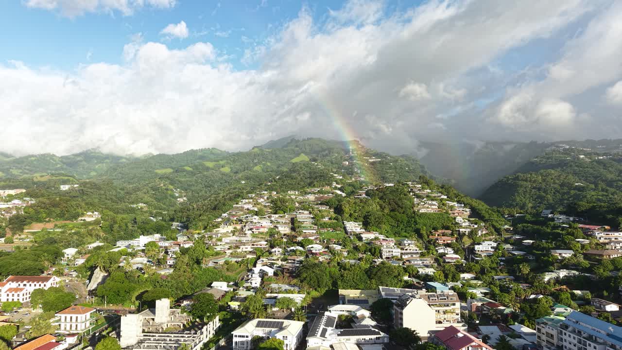Papeete, Tahiti, French Polynesia. Drone Shot of Real Rainbow Above Hills and Hillside Buildings