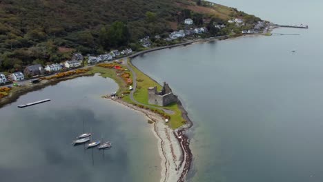 aerial view of lochranza castle on the isle of arran on an overcast day, scotland