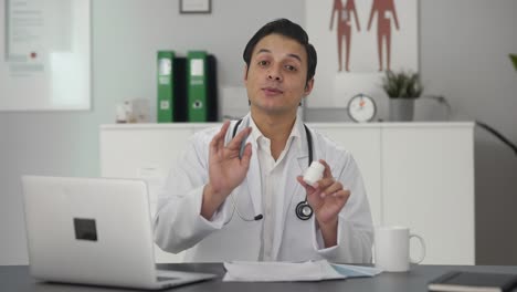 happy indian doctor giving medicine to patient