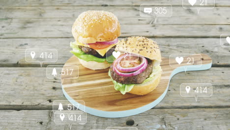 displaying animation of social media icons, two burgers on wooden board