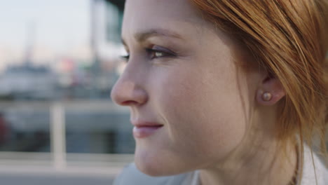 close-up-portrait-of-beautiful-red-head-business-woman-looking-at-camera-turns-head-slow-motion-smiling-confident-real-people-series