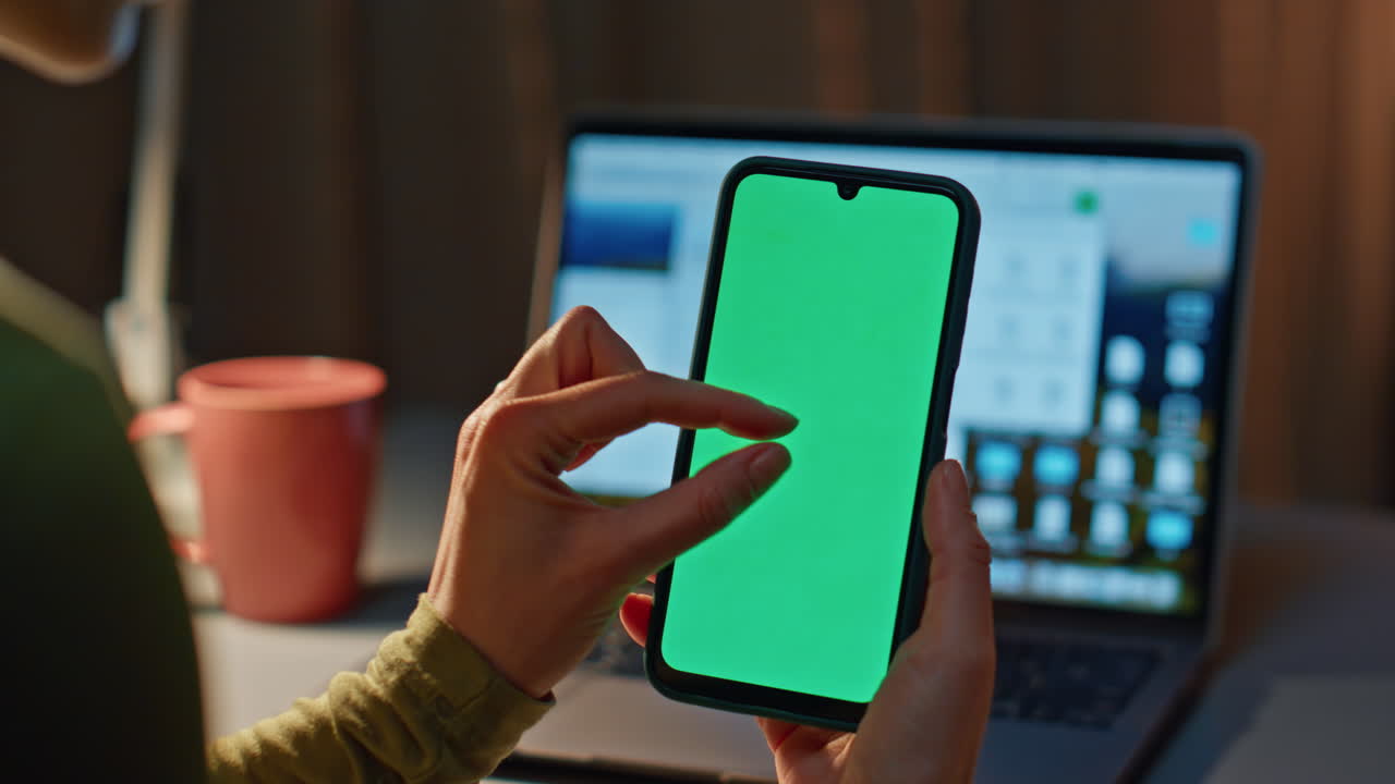 Girl shopping mockup smartphone sitting late evening at home with laptop closeup