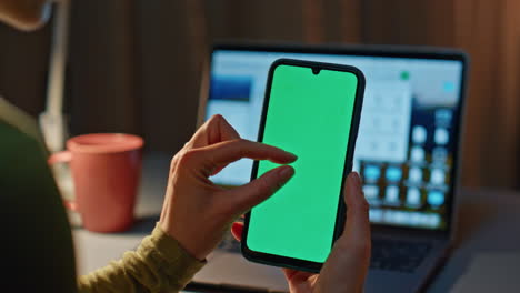 girl shopping mockup smartphone sitting late evening at home with laptop closeup