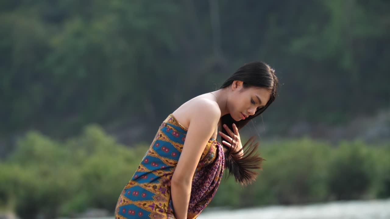 Woman in Traditional Clothing by the River