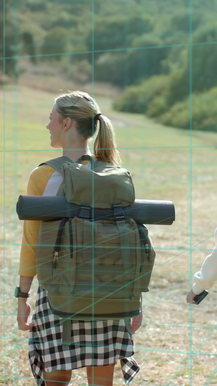 Vertical video: Hiker walking toward hills, trail urging forward, pal exiting, AR tags on pack mat