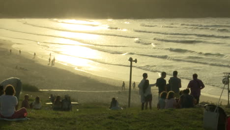 sunset beach scene with people relaxing