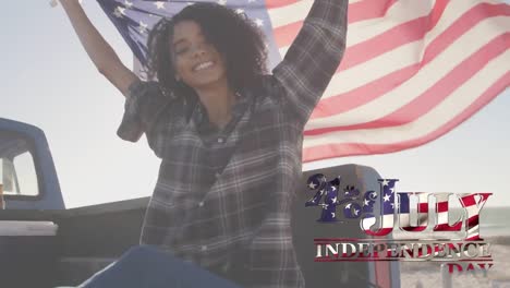 Young-mixed-race-holding-US-flag-with-independence-date-foreground