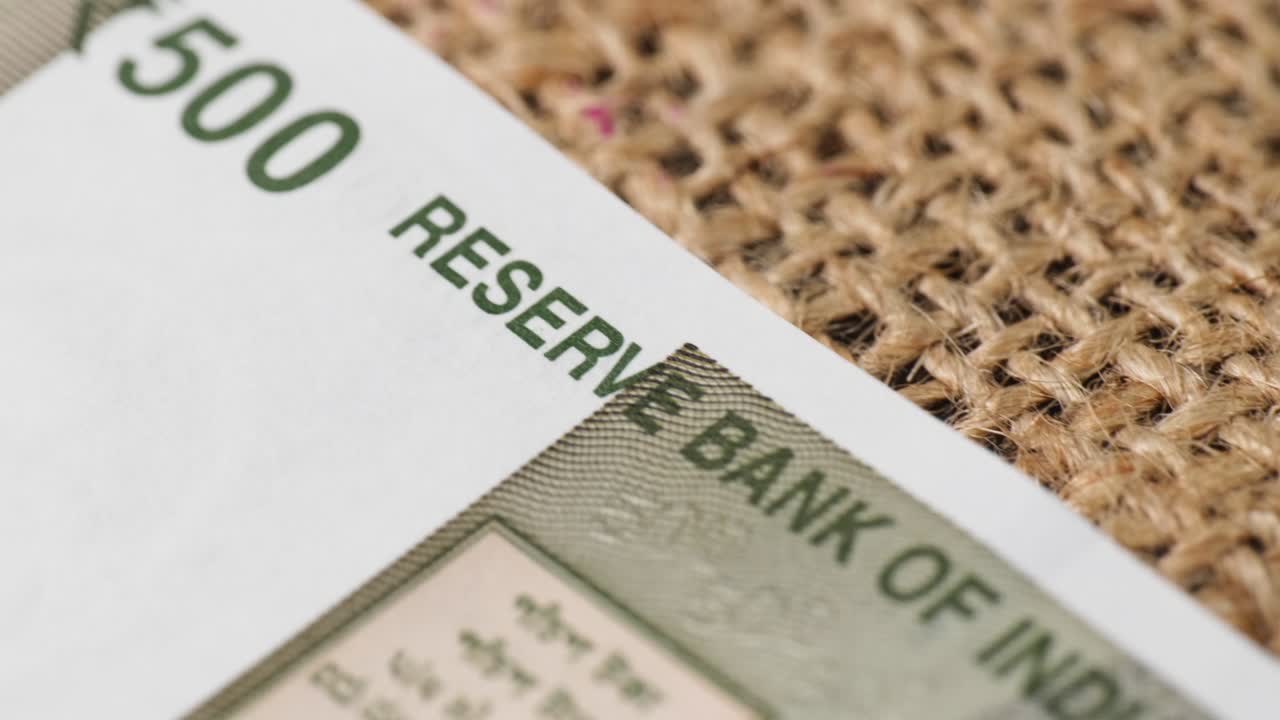 Indian currency of 500rs note in jute cloth with macro details, five hundred rupee text with national flag and red fort. close up shot, push in shot, 4k.