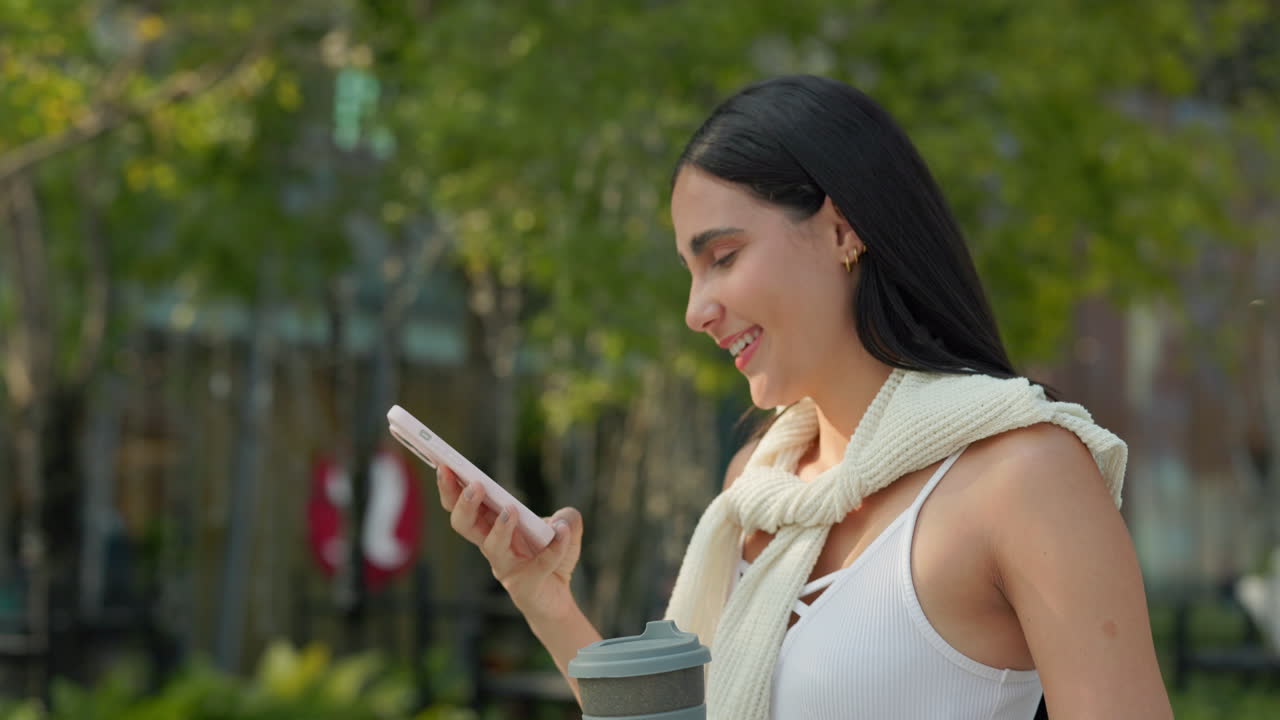Young woman using her smartphone outdoors
