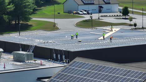 solar panels being installed on large church in america with shingle and industrial metal roof