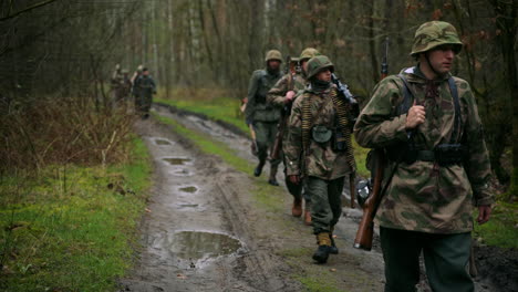 german soldiers marching through a forest