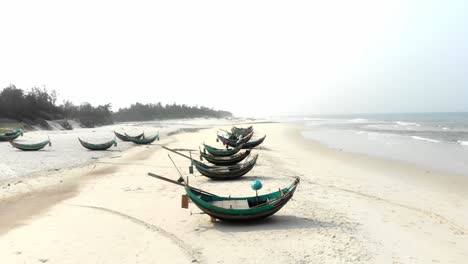 local fishing boats on shore at trung thanh beach vietnam, aerial