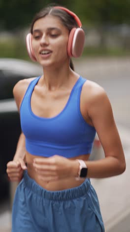 woman running outdoors with headphones