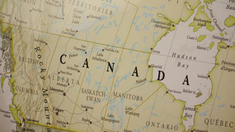 a close-up view of a detailed map of canada, showing its provinces, territories, and major cities