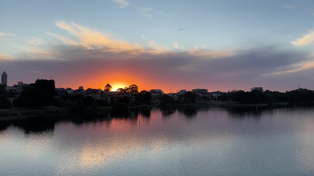 Orange sunset and reflection over Swan River in East Perth, Western Australia