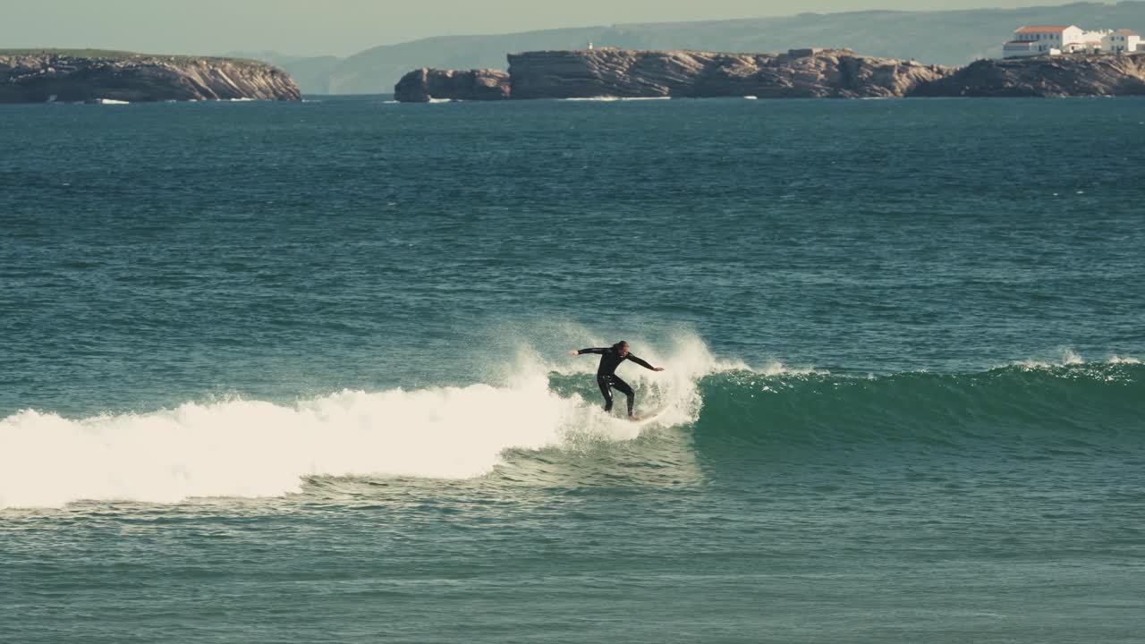 Surfer on small wave, follow view