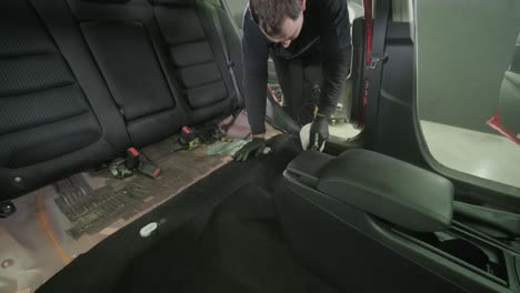 professional car cleaning. сar wash. interior detailing. dry clean and detail a car interior. deep seats cleaning. wiping foam in car wash. cleaning the car panel from dust. a vacuum cleaner