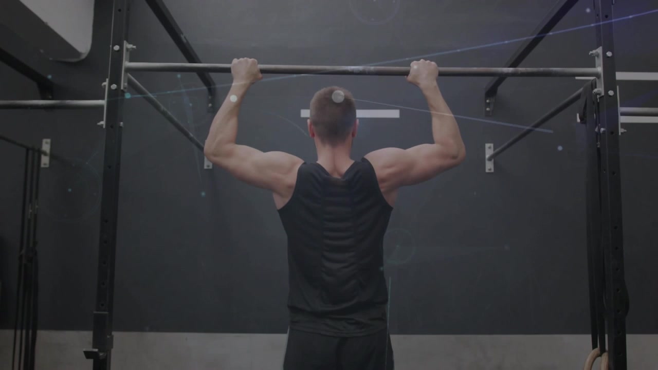 Man gripping pullup bar in gym and doing pull-ups, engaging lats as light overlays appearing