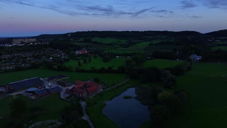 panning right footage of dark urban landscape below dark sunset above