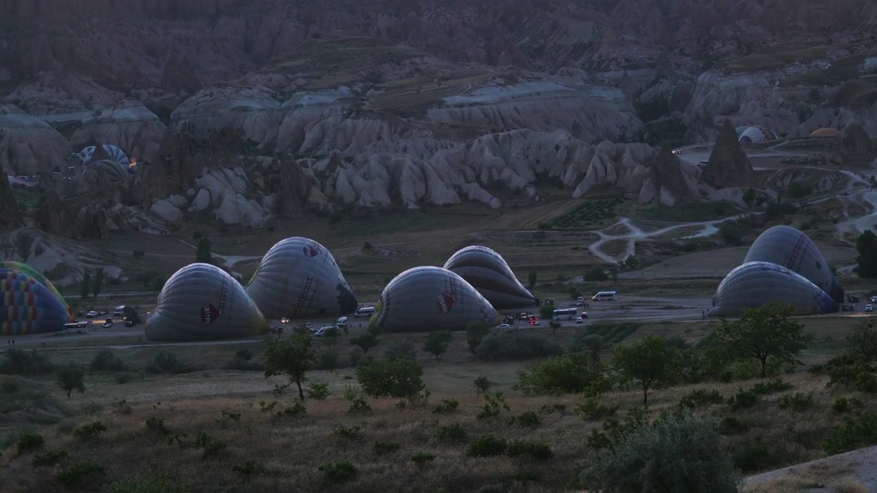 Hot Air Balloons Preparing for Flight at Sunrise in Cappadocia
