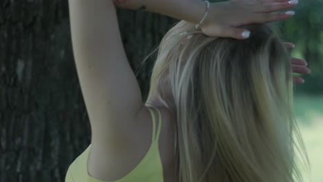 happy beautiful young girl dancing of freedom in summer park with trees in the background.