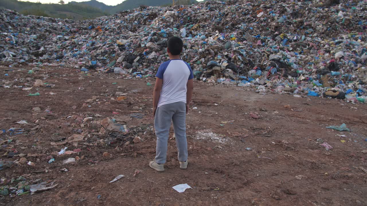A child standing in a landfill
