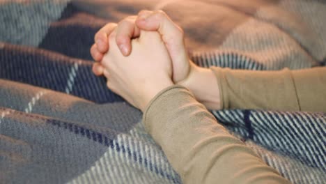 praying with joined hands with extreme hope, closeup