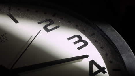 Close-up-shot-of-retro-clock-lighting-in-dark-room-with-second-hand-in-motion-in-mystic-room