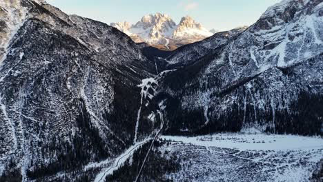 rock formation shot during golden hour in the italian dolomites mid winter (drone footage)