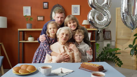 portrait of joyous family at grandmother birthday dinner